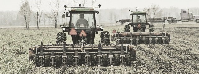 2 Tractors Plowing Farm Land