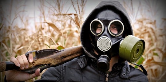 Gas Mask On A Man With A Rifle