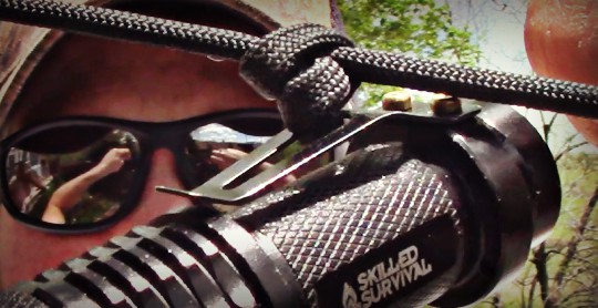 tying a knot to the clip of a firehawk flashlight