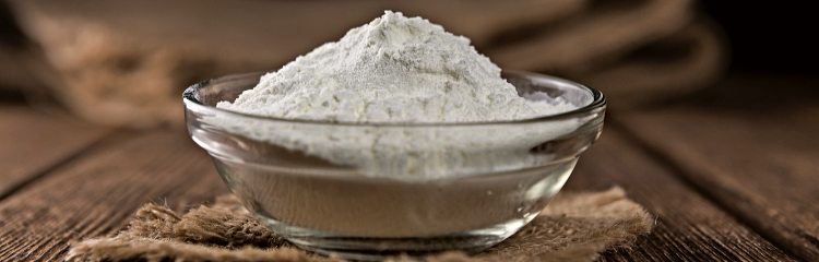 Heap of Milk Powder (selective focus) on an old wooden table